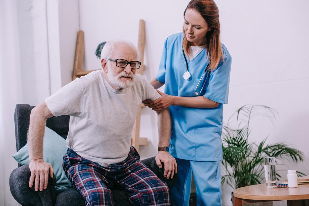 stock-photo-nurse-helping-old-man-stand